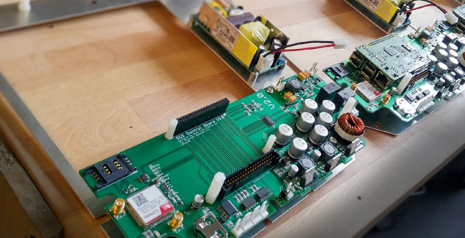 DCS control circuit boards and power supplies laid out on a wooden workbench